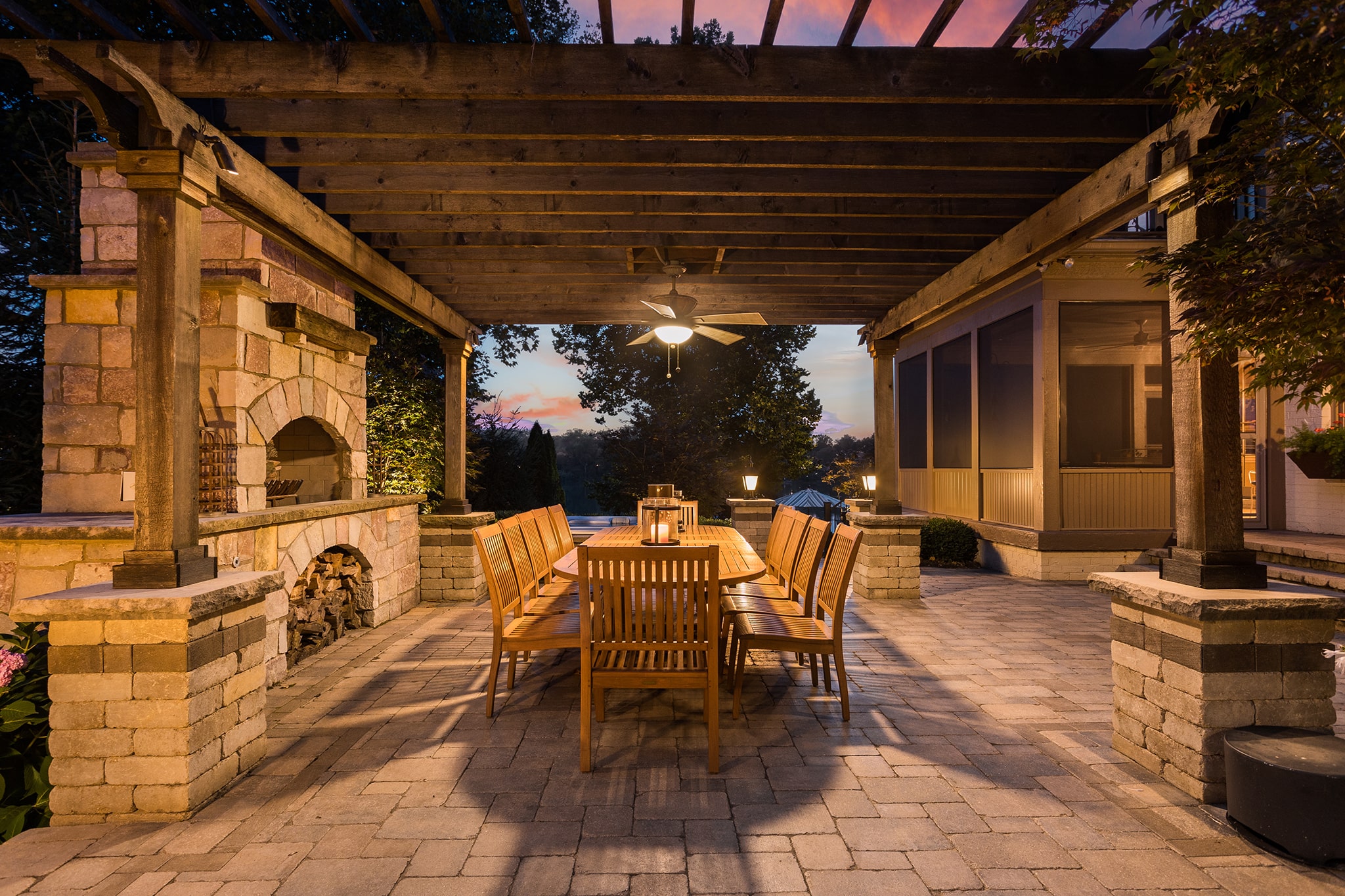 Paver patio dining area with stone fireplace