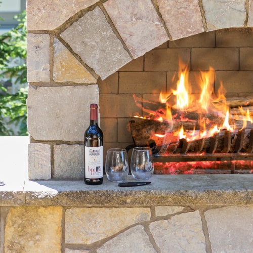 BPI labeled wine resting on a sophisticated stone fireplace