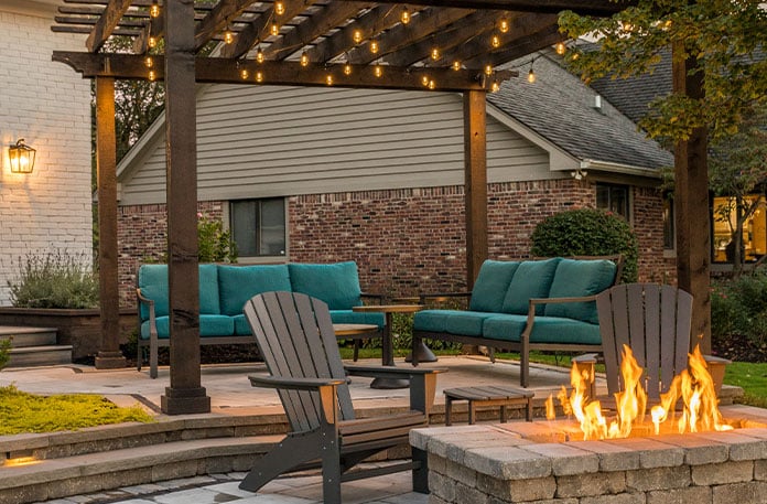 Outdoor living space with string lights and fire feature.
