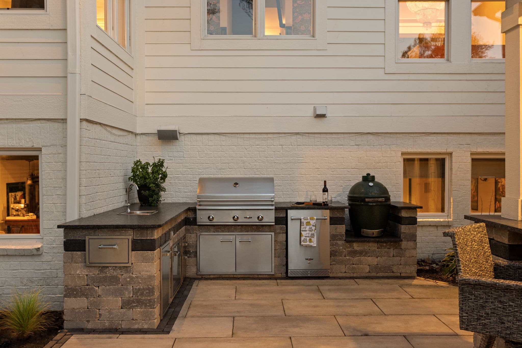 Outdoor kitchen with built-in sink, grill and smoker.