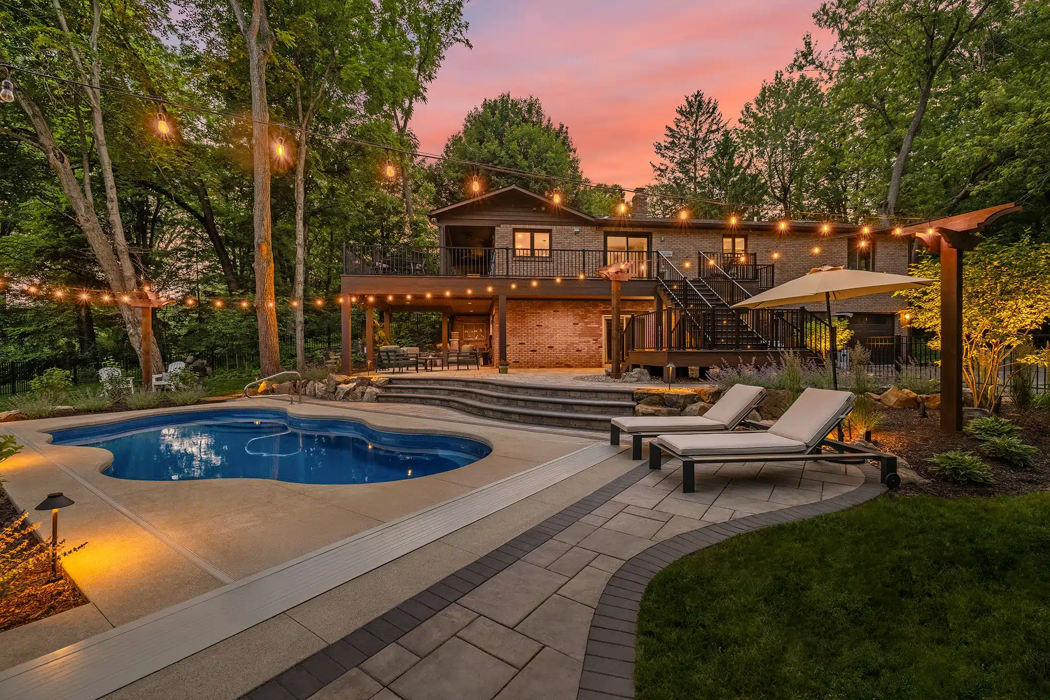 Backyard with organic shapes incorporated throughout the design such as the pool, stairs and patio edge.